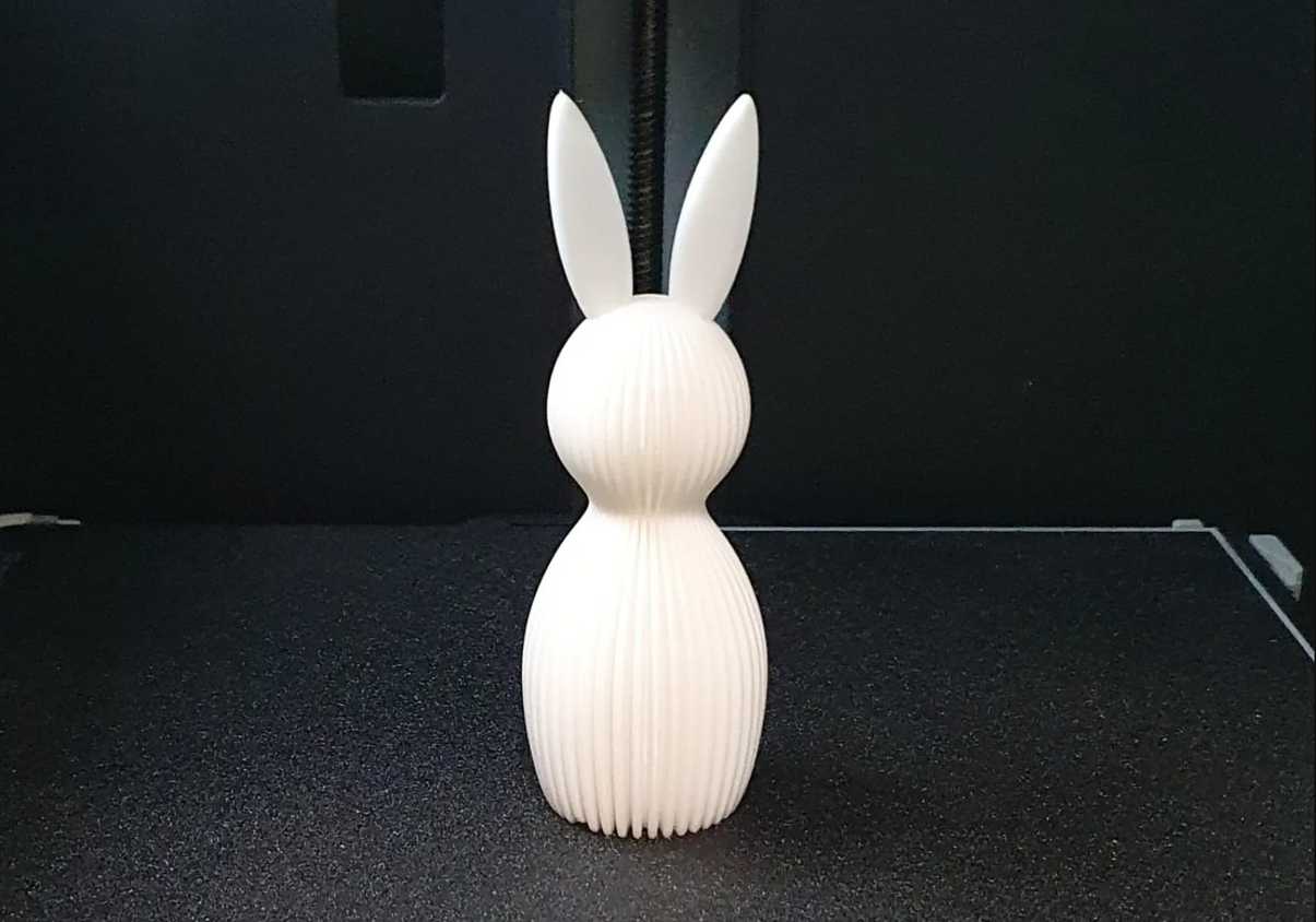 A white easter bunny on a 3D printer bed