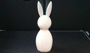 A white easter bunny on a 3D printer bed