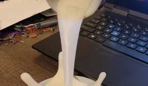 A flooting 3D printd coffee splush near a laptop