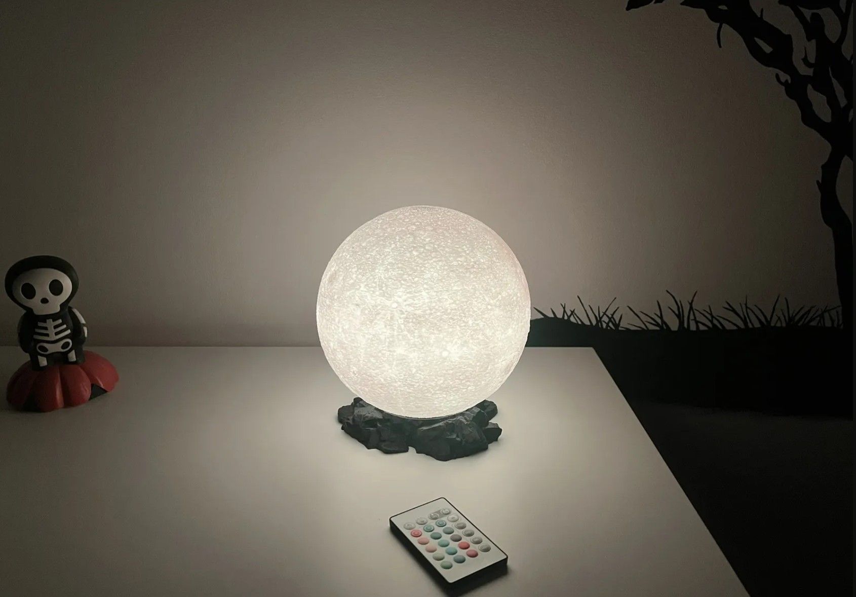 A 3D printed lamp moon on the table shining light