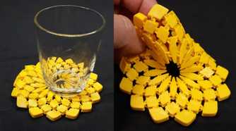 A glass on top of a 3D printed sunflower fabric and hand holding it on another side
