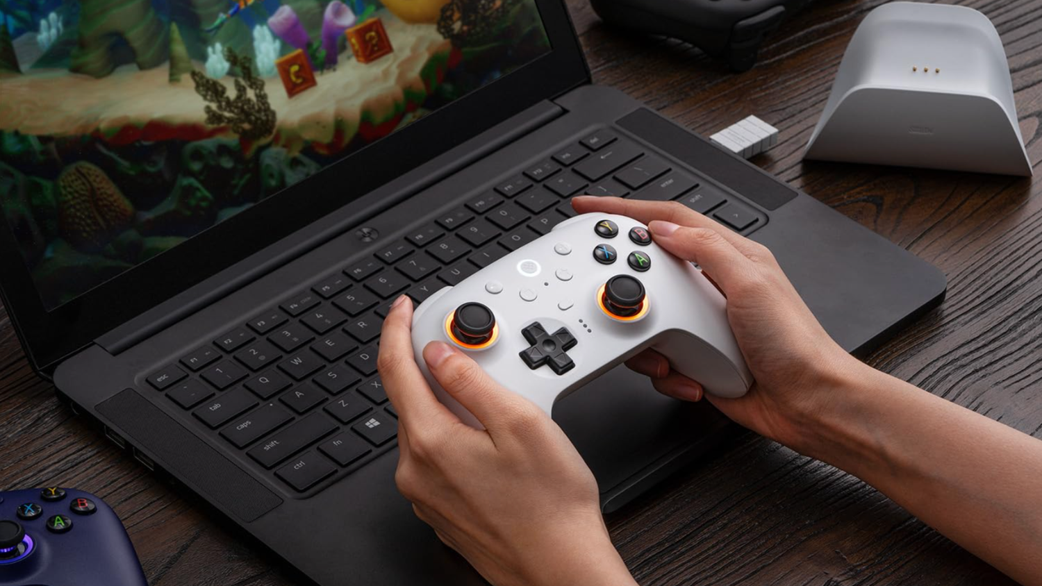 8BitDo Ultimate 2 Wireless Controller for Windows & Android in front of a laptop