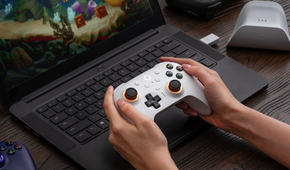 8BitDo Ultimate 2 Wireless Controller for Windows & Android in front of a laptop