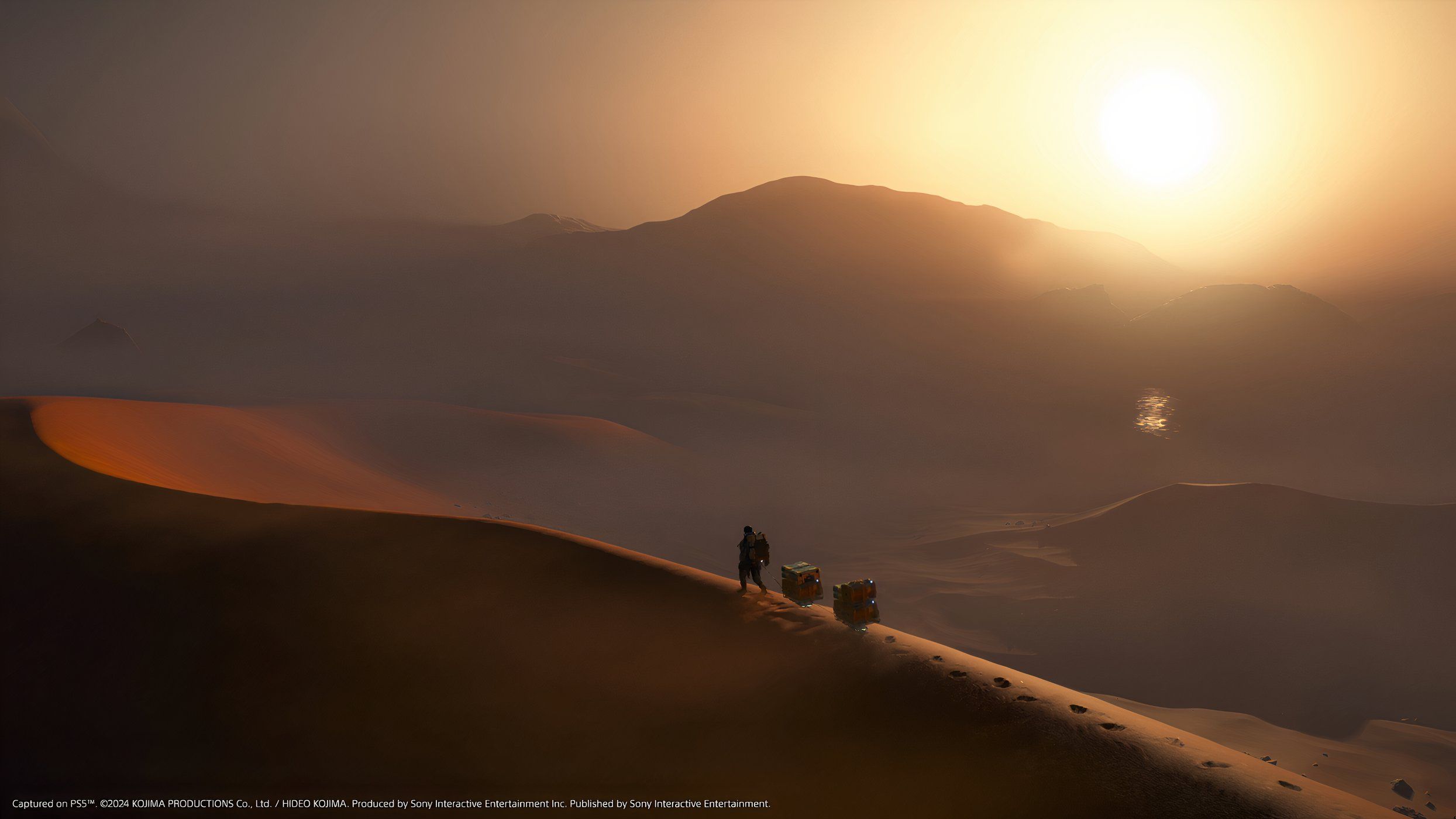 An image from the game Death Stranding 2: On The Beach, showing Sam walking along a sand dune as the sun sets.