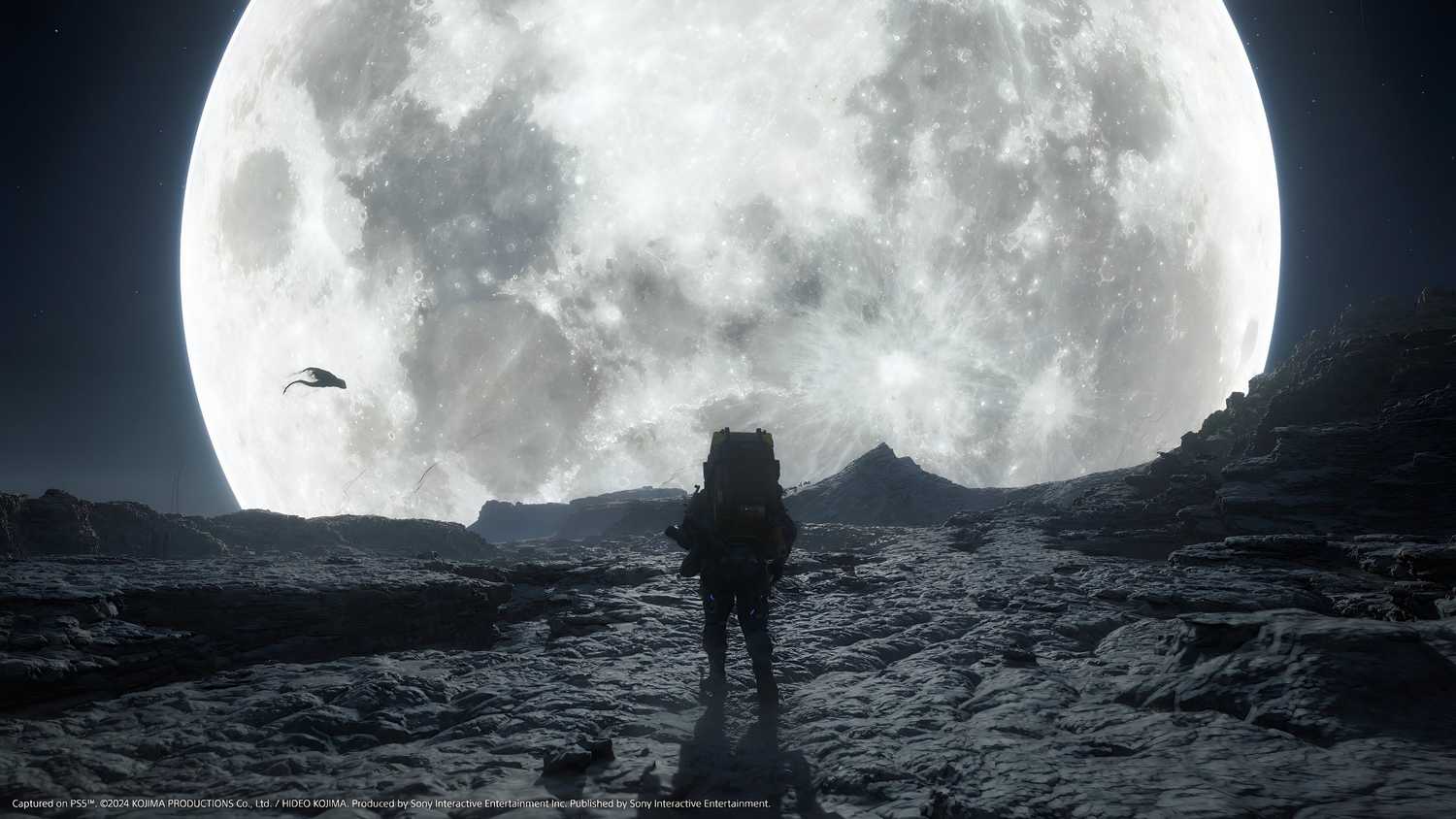 An image from the game Death Stranding 2: On The Beach, showing Sam's silhoutte against a huge, bright white moon.