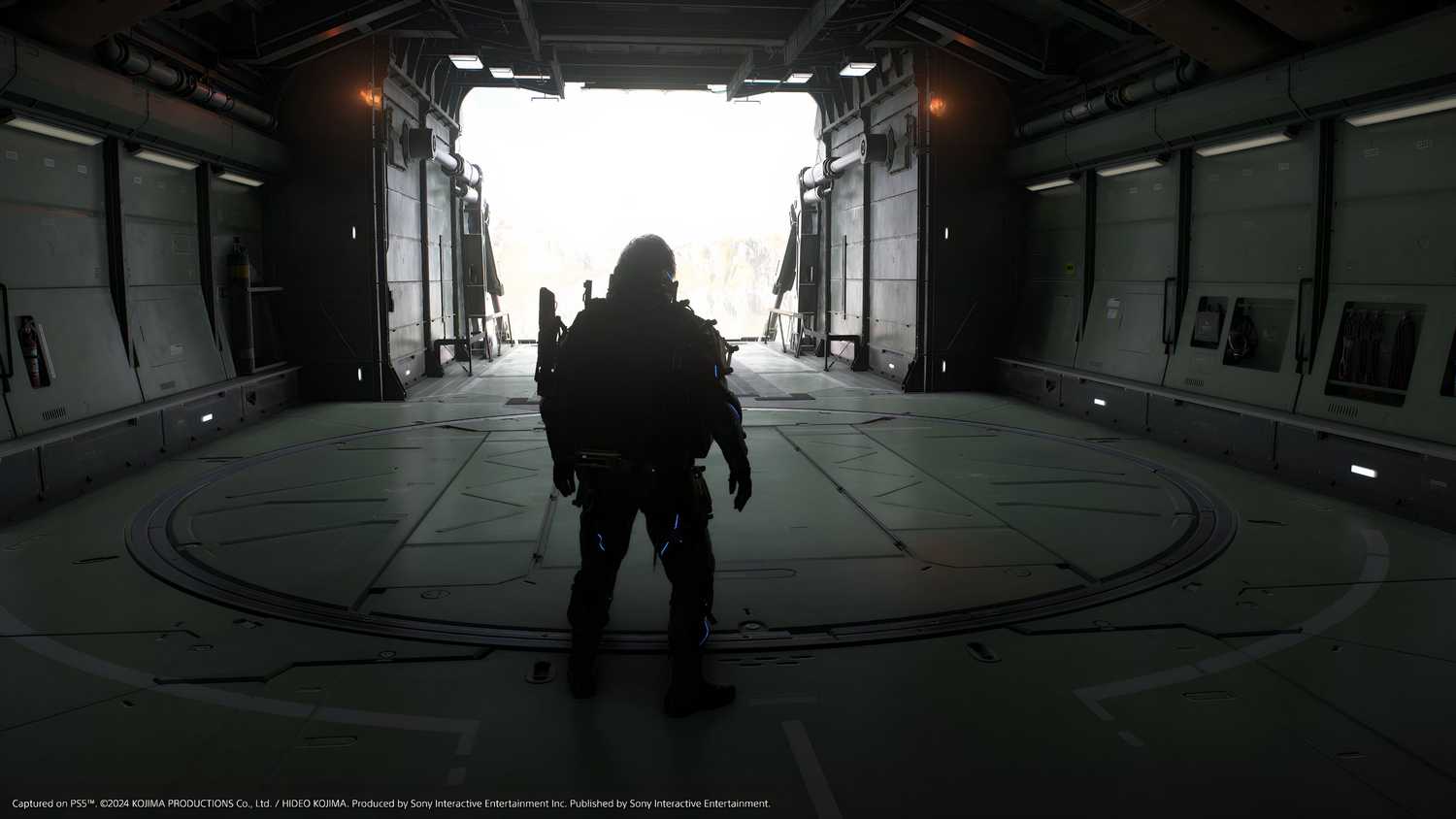 An image from the game Death Stranding 2: On The Beach, showing Sam's silhouette against an airplane hangar.