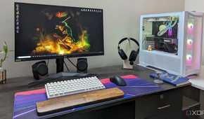 A desktop PC setup with a large mouse pad, keyboard, mouse and headphone on the desk