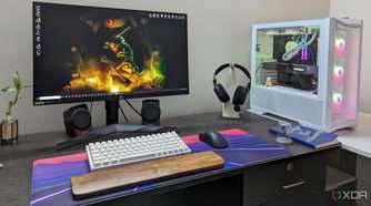 A desktop PC setup with a large mouse pad, keyboard, mouse and headphone on the desk