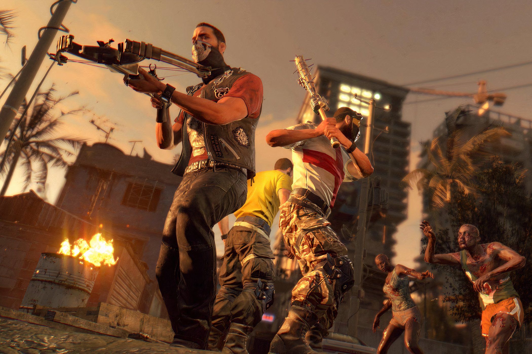 A screenshot from Dying Light, showing three people fending off zombies.