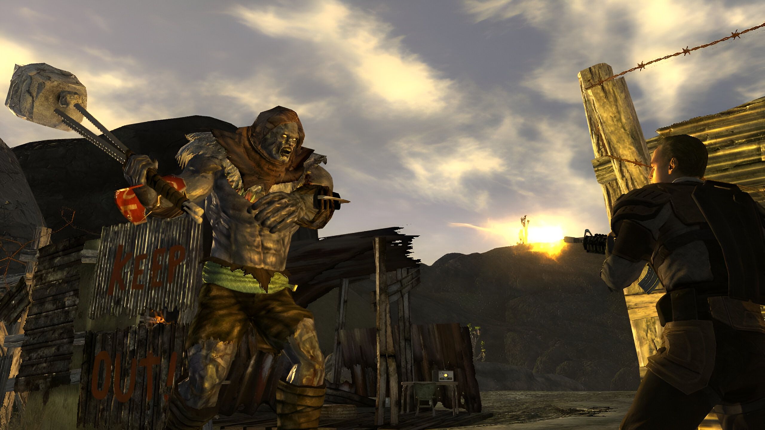An image from the game Fallout: New Vegas, showing a man shooting at a huge mutant.