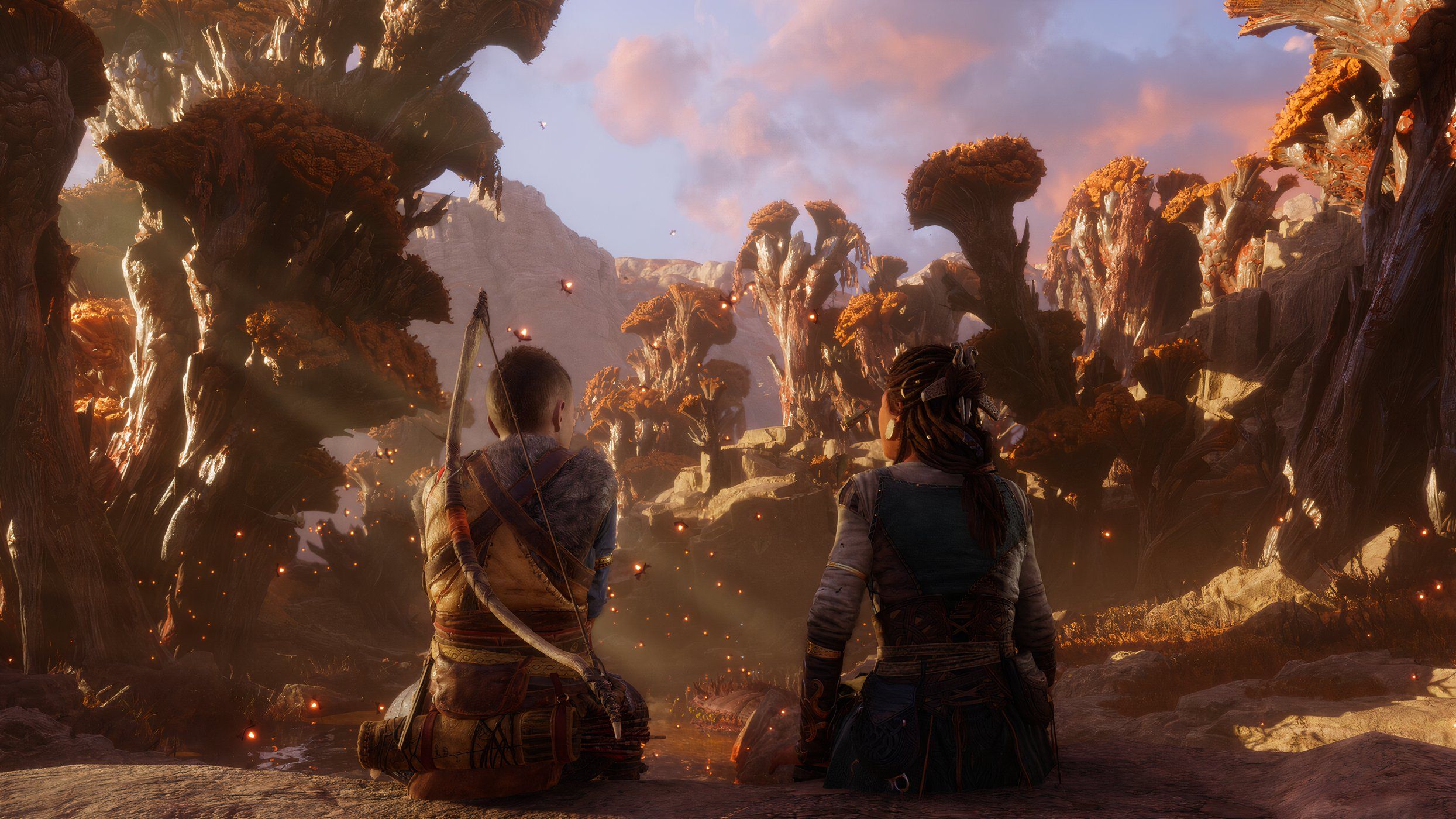 An image from the game God of War Ragnarok, showing Atreus and Angrboda sitting in Ironwood, a mythical forest.