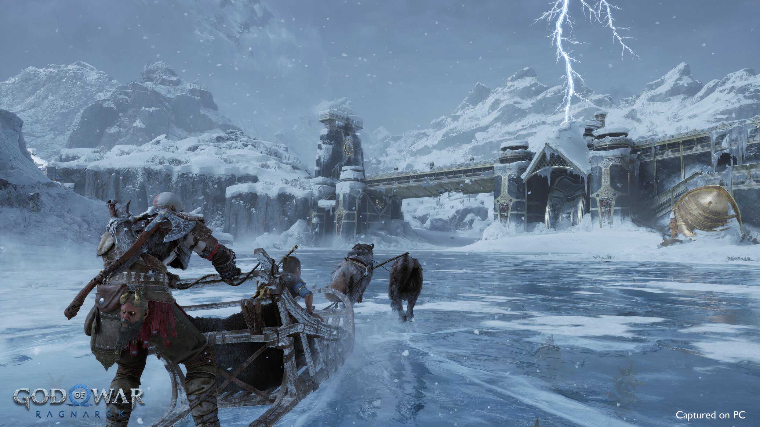 An image from the game God of War Ragnarok, showing Kratos and his son on a sled pulled by two wolves across an icy lake.