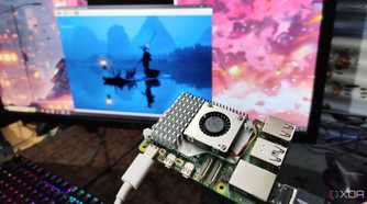 A photo of person holding a Raspberry Pi in front of a monitor