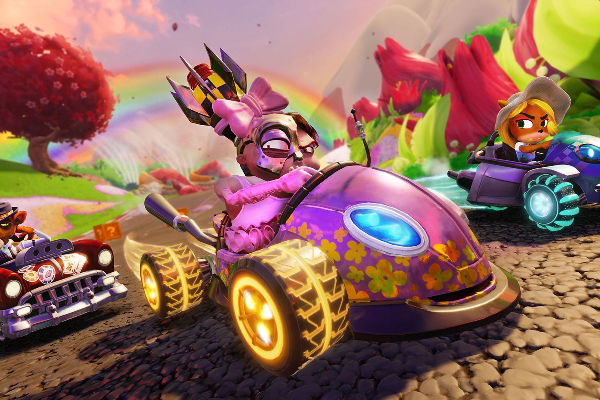 Crash Team Racing racers driving under rainbow