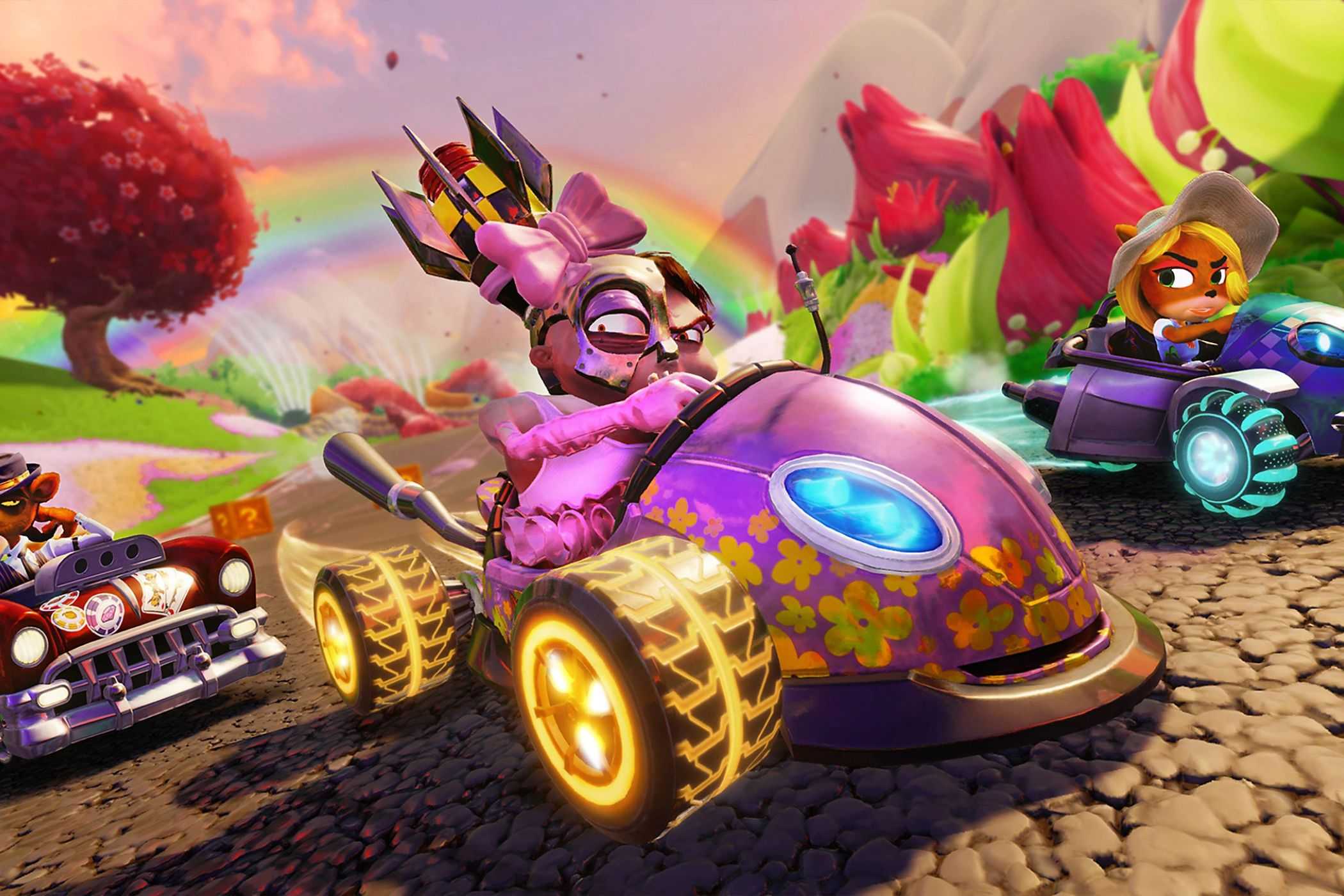 Crash Team Racing racers driving under rainbow