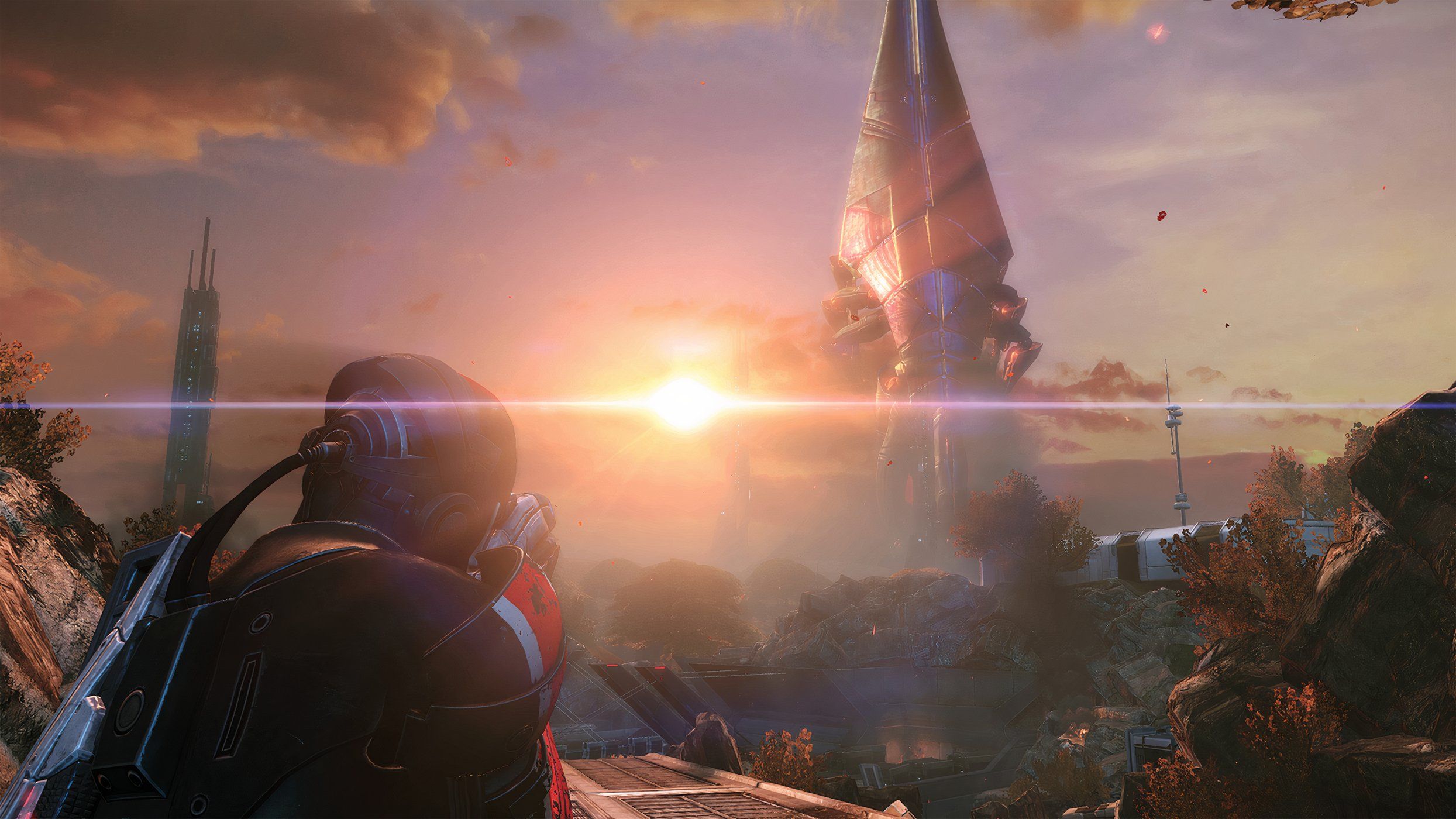 An image from Mass Effect Legendary Edition, showing the player character looking at a huge spire-like building in the horizon.