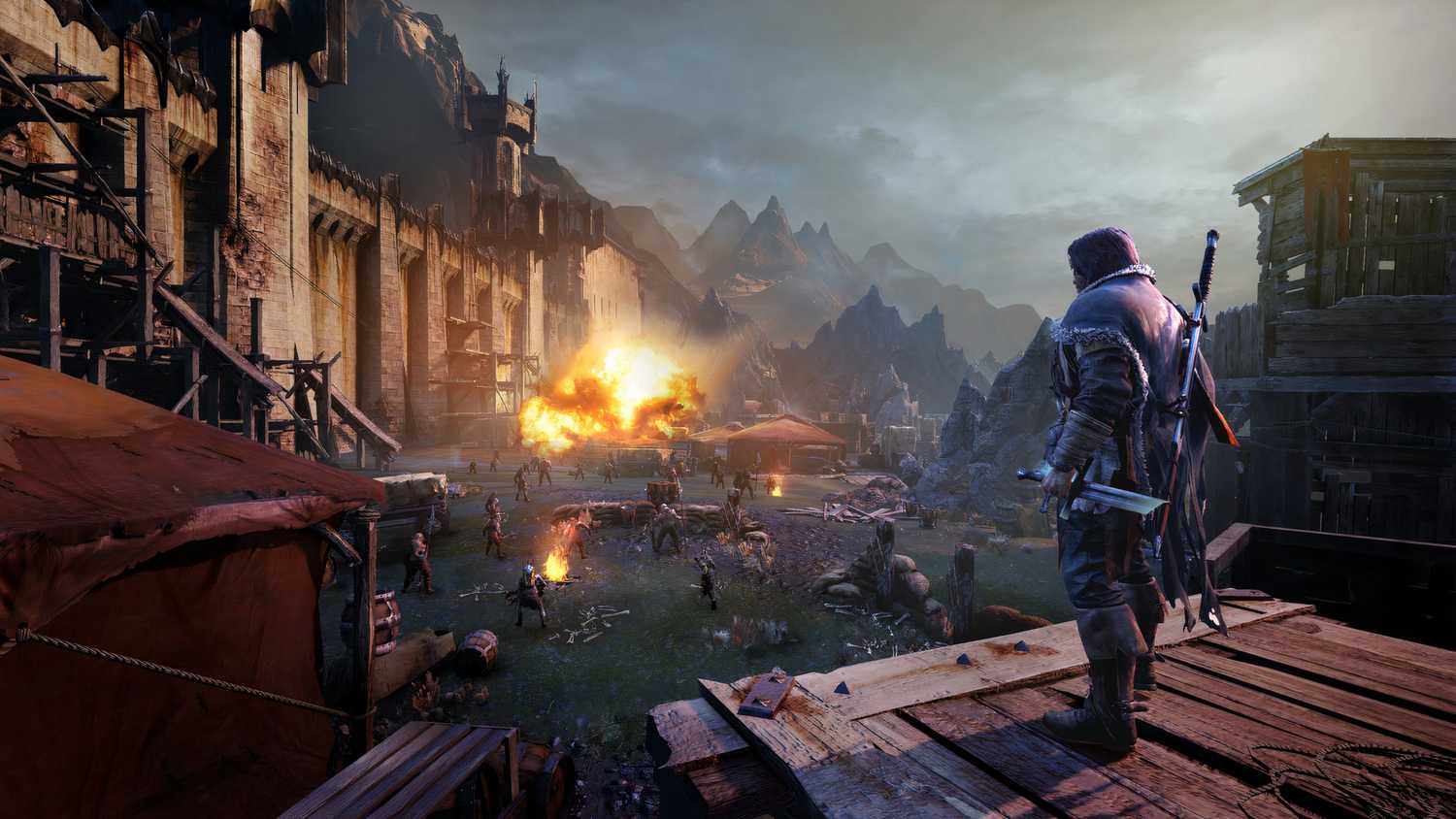 An image from Middle-Earth: Shadow of Mordor, showing the protagonist looking at a battle-ruined arena.