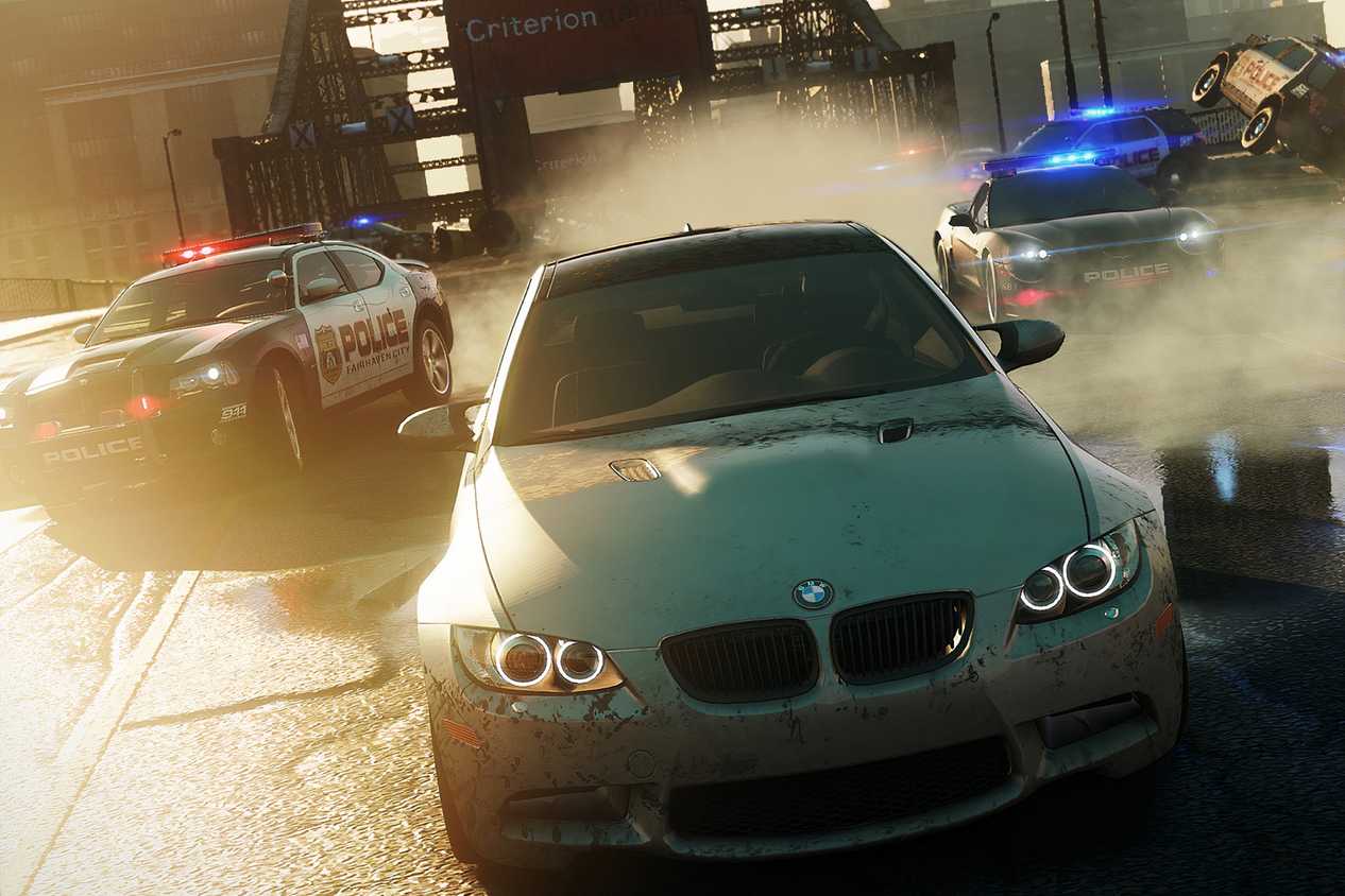 A screenshot from Need for Speed: Most Wanted 2012, showing a silver BMW being chased by cop cars.