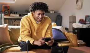 Nintendo Switch 2 player on Couch playing in handheld mode