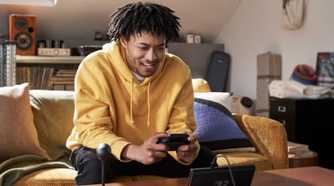 Nintendo Switch 2 player on Couch playing in handheld mode