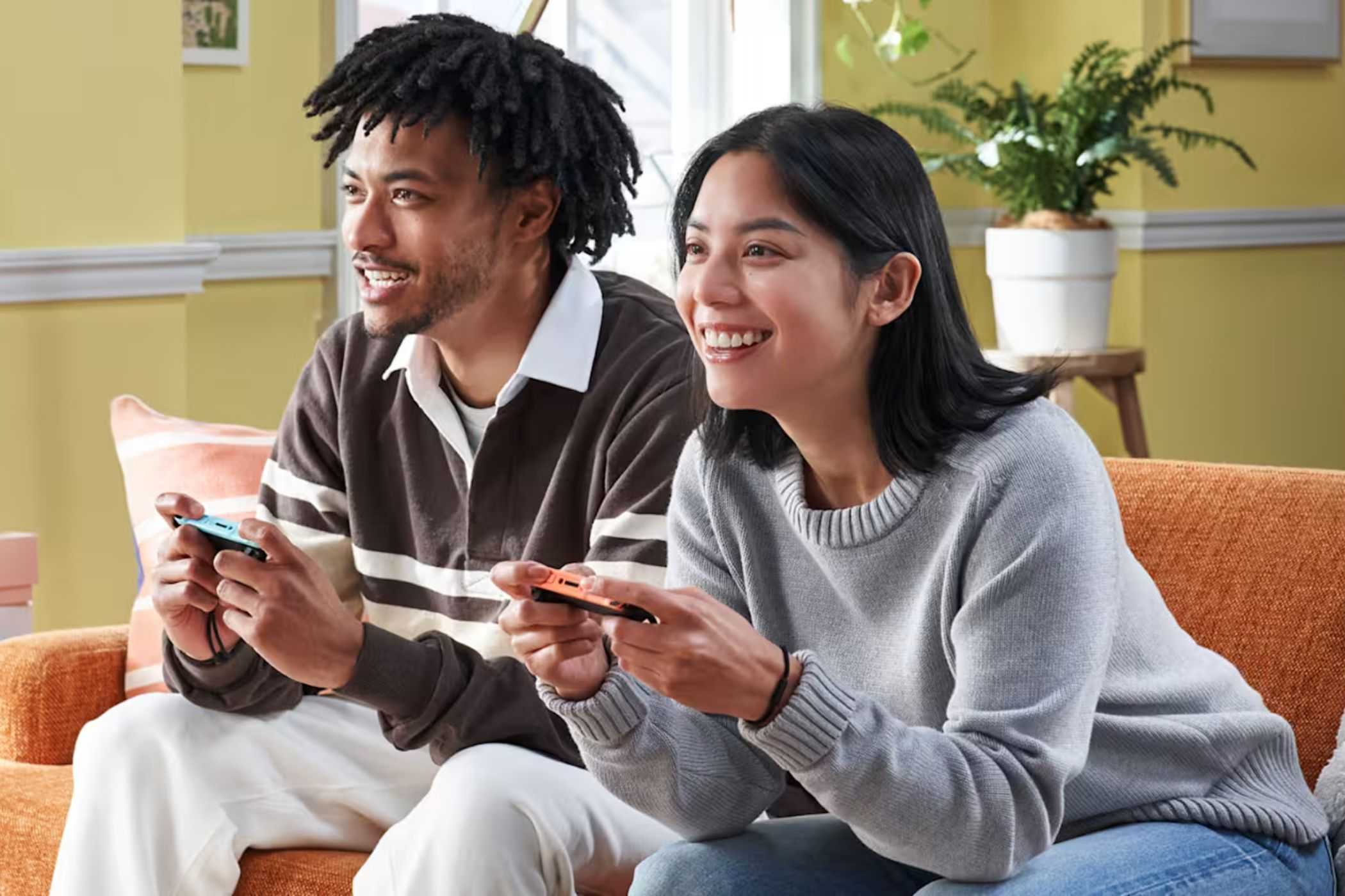 Nintendo Switch 2 players sitting on couch