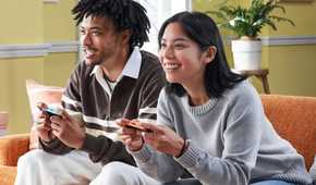 Nintendo Switch 2 players sitting on couch