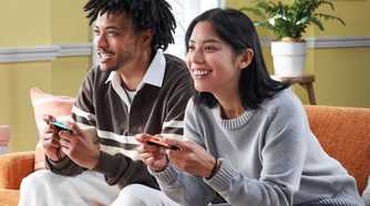 Nintendo Switch 2 players sitting on couch
