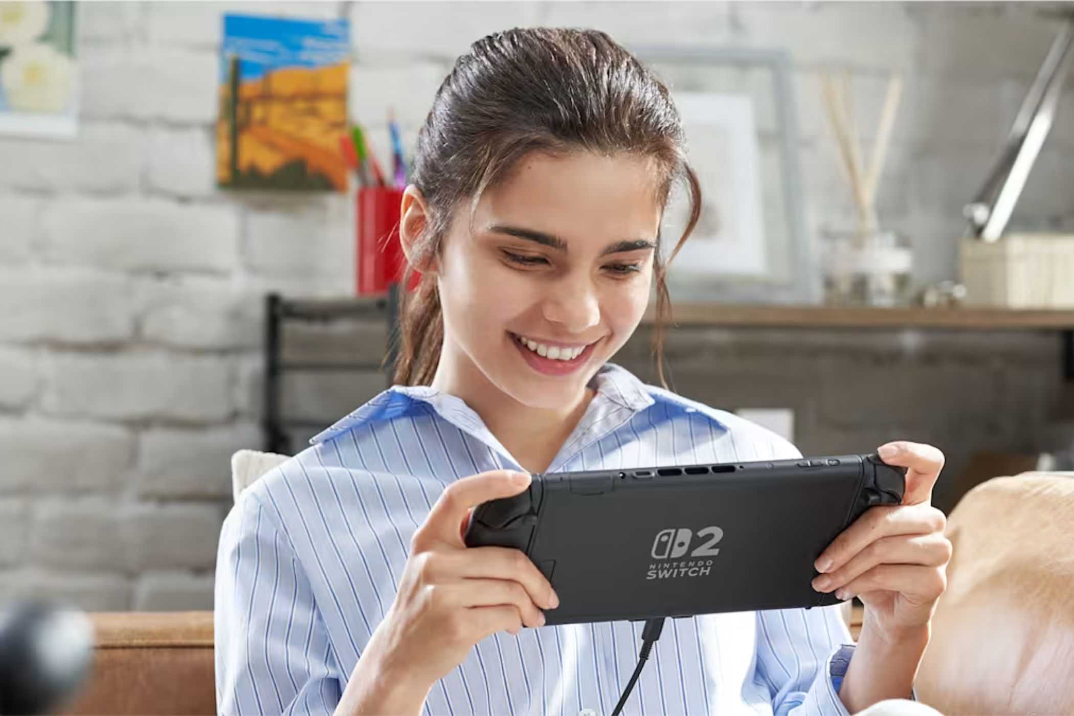 Nintendo Switch 2 player holding system in handheld mode