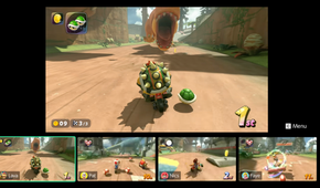 A screenshot of a Nintendo Switch 2 displaying Mario kart World with the GameChat interface showing off four players playing the same game