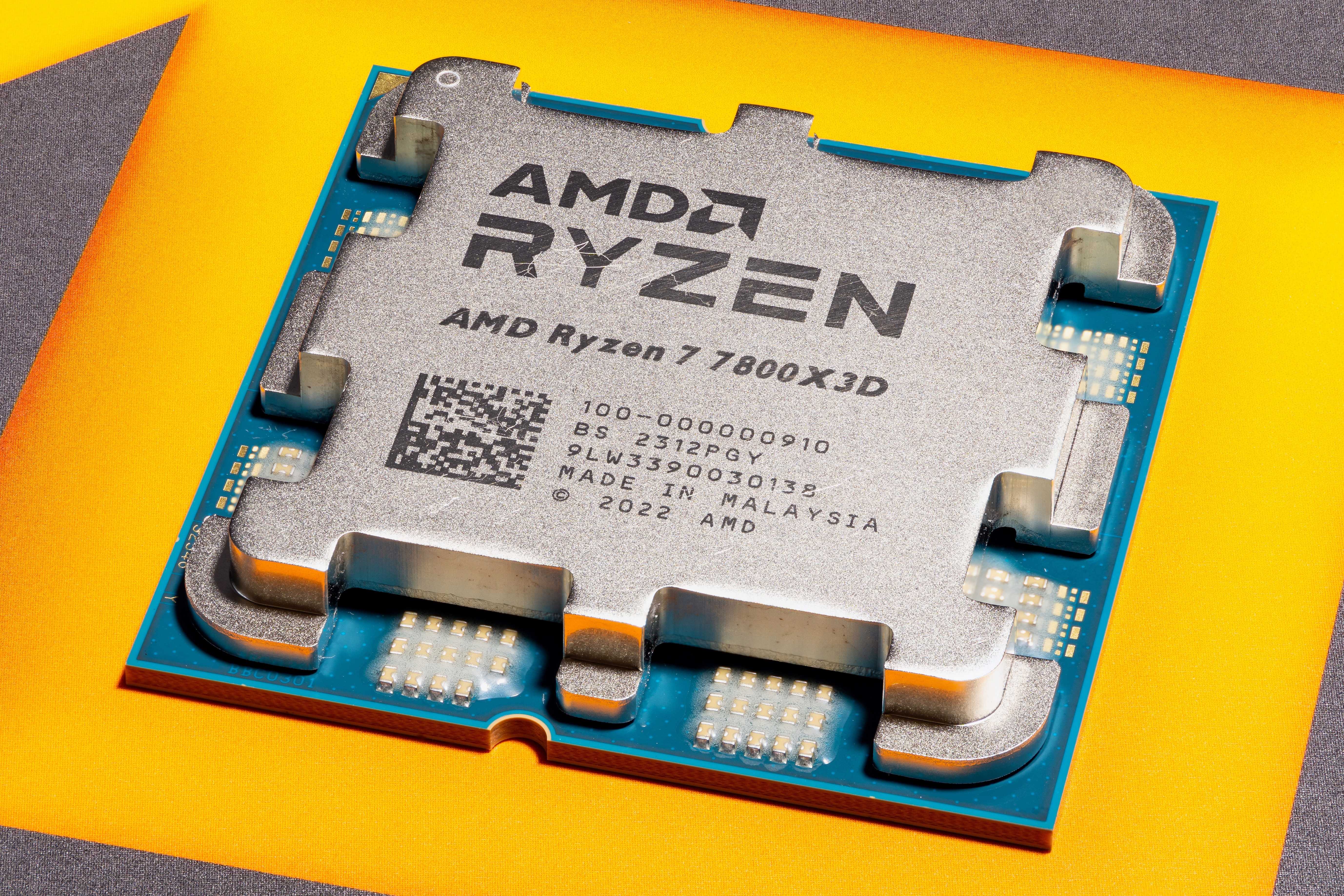 Close-up of an AMD Ryzen CPU on a yellow background
