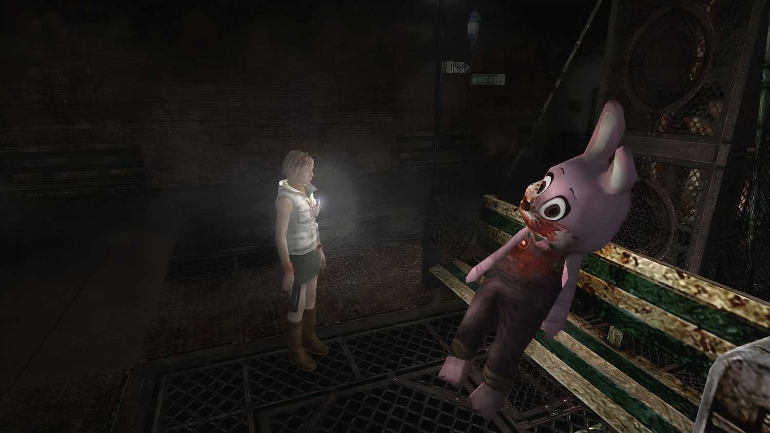 A screenshot from the 2012 game "Silent Hill HD Collection", showing Heather Mason shining a flashlight at a huge pink bunny outfit seated on a rusted bench.