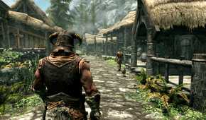 An image from the game The Elder Scrolls V: Skyrim, showing the Dragonborn character walking down a paved village road.
