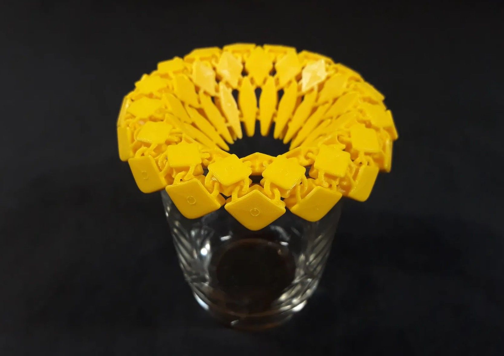 Sunflower fabric coaster on top of a glass