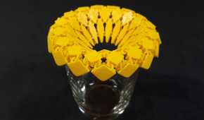 Sunflower fabric coaster on top of a glass