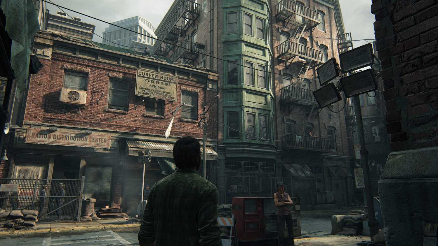 A screenshot from The Last of Us Part I on PC, showing Joel looking at the Boston quarantine zone.
