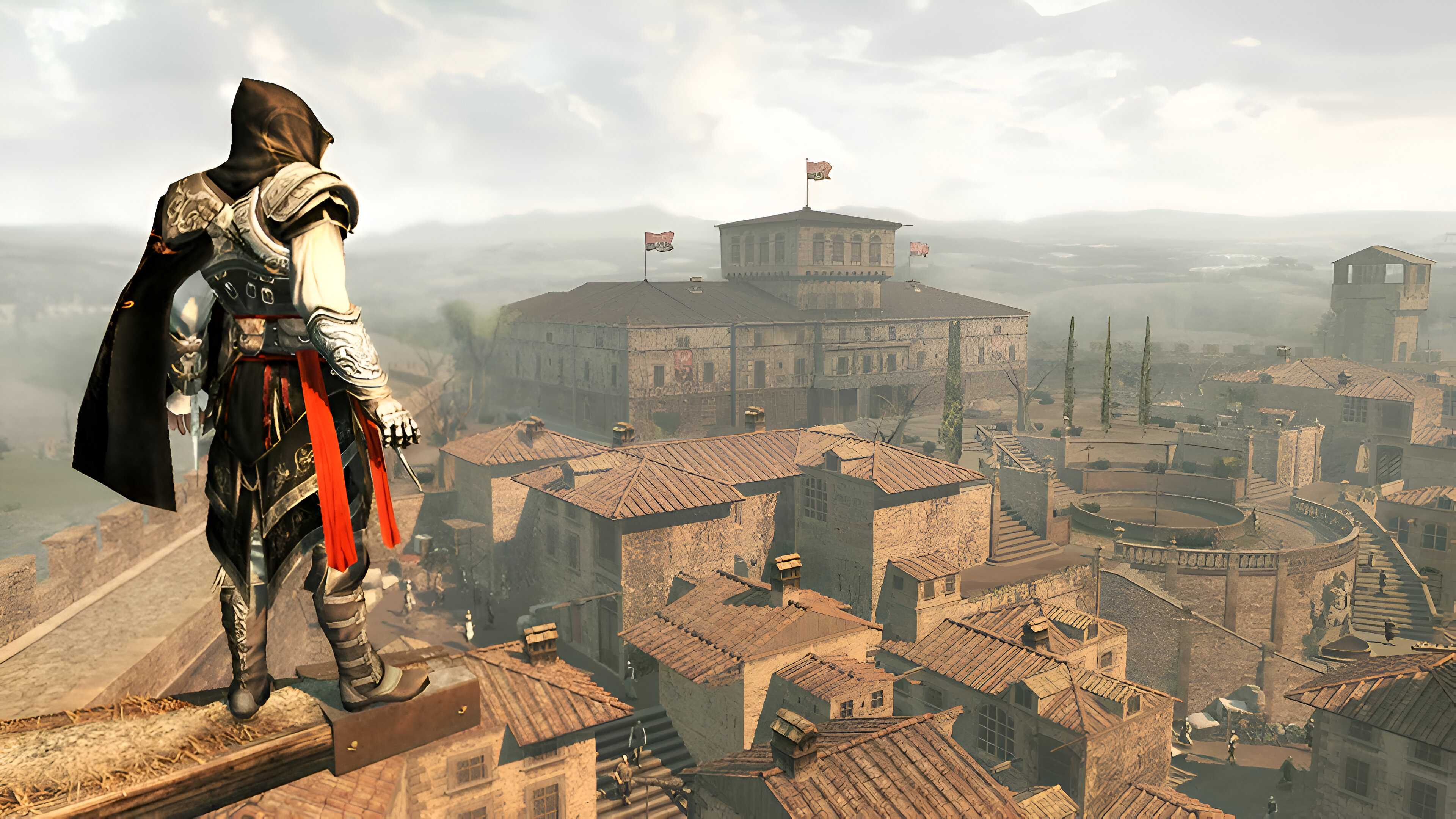 Ezio standing on a ledge overlooking the Montereggioni Villa in Assassin's Creed II.