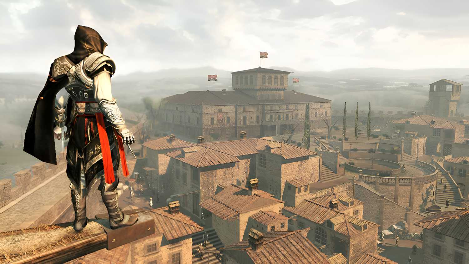 Ezio standing on a ledge overlooking the Montereggioni Villa in Assassin's Creed II.