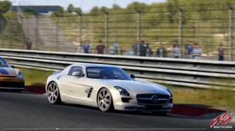 A screenshot from the game "Assetto Corsa", showing a silver Mercedes-AMG car racing on the track as viewers look on at the sidelines.