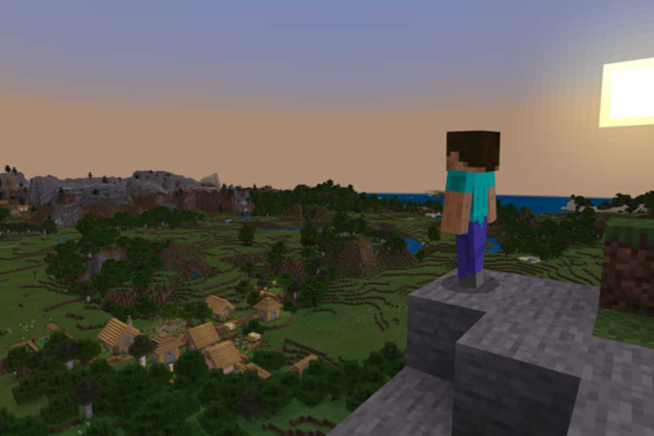 Minecraft steve standing on cliff at sunset