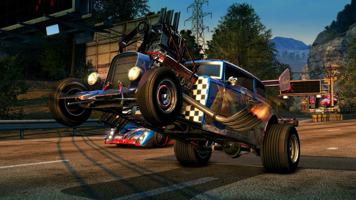 A screenshot from the game Burnout Paradise Remastered, showing a hot-rod car executing a wheelie.