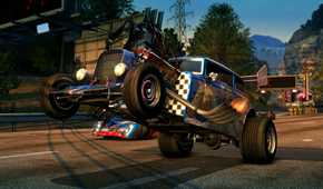 A screenshot from the game Burnout Paradise Remastered, showing a hot-rod car executing a wheelie.