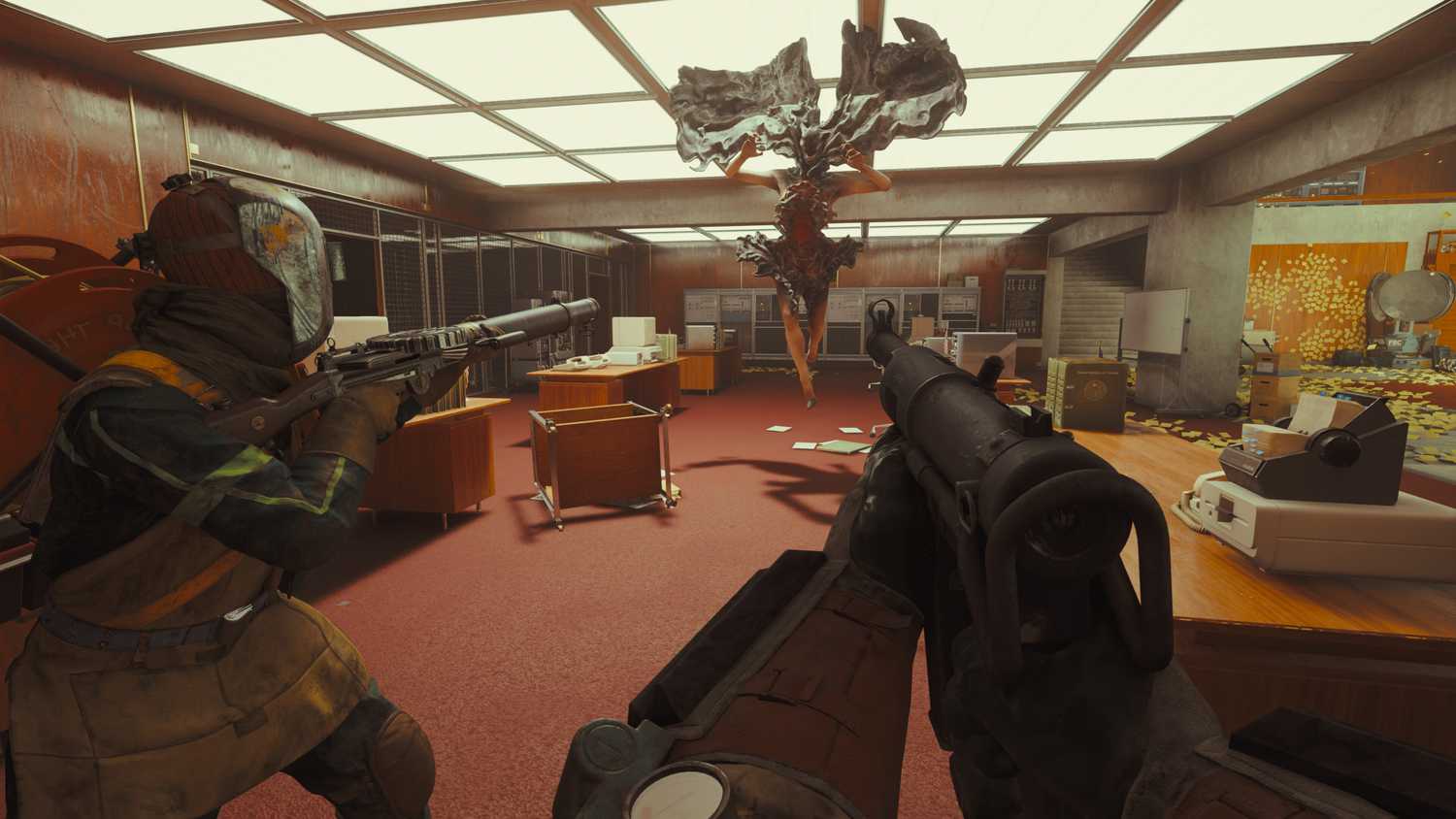A screenshot from the game "FBC: Firebreak", showing an office environment as players aim their weapons at an airborne hostile entity.