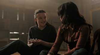 A screengrab from episode 4 of the HBO show The Last of Us Season 2, showing Ellie and Dina smiling at each other.