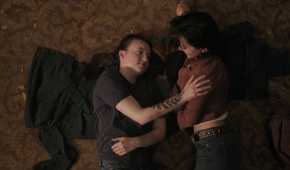 A screengrab from episode 4 of the HBO show The Last of Us Season 2, showing Ellie and Dina lying on the ground together.