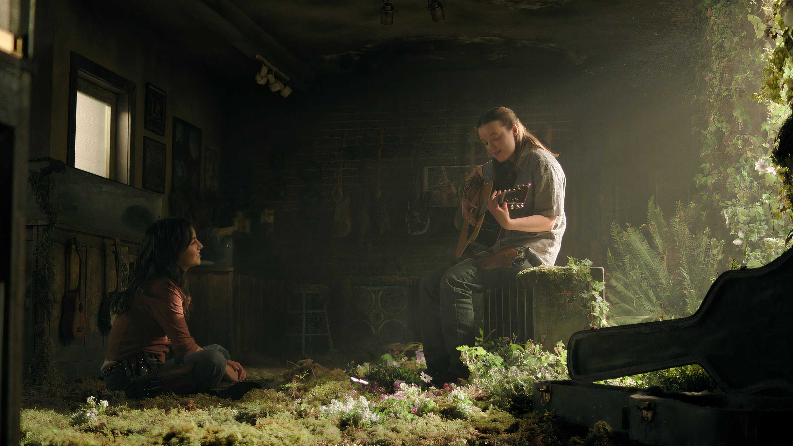 A screengrab from episode 4 of the HBO show The Last of Us Season 2, showing Ellie playing the guitar for Dina.