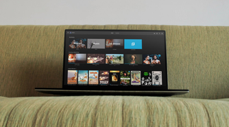 A laptop is kept on a sofa