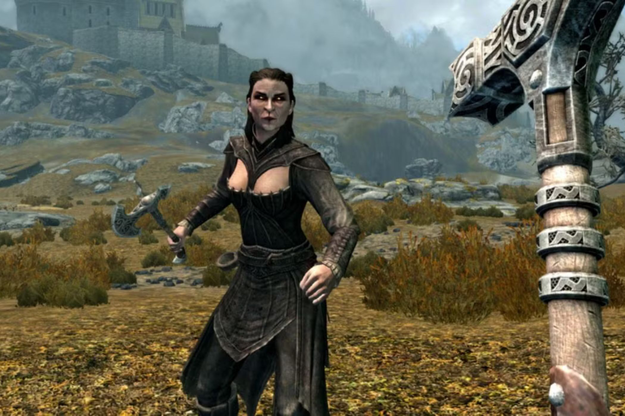 Skyrim player with hammer fighting woman in field