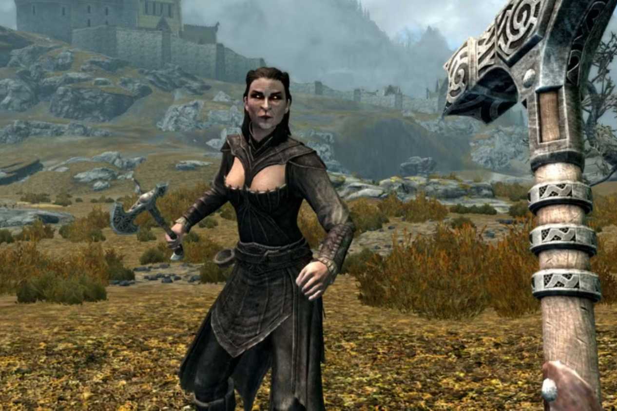 Skyrim player with hammer fighting woman in field