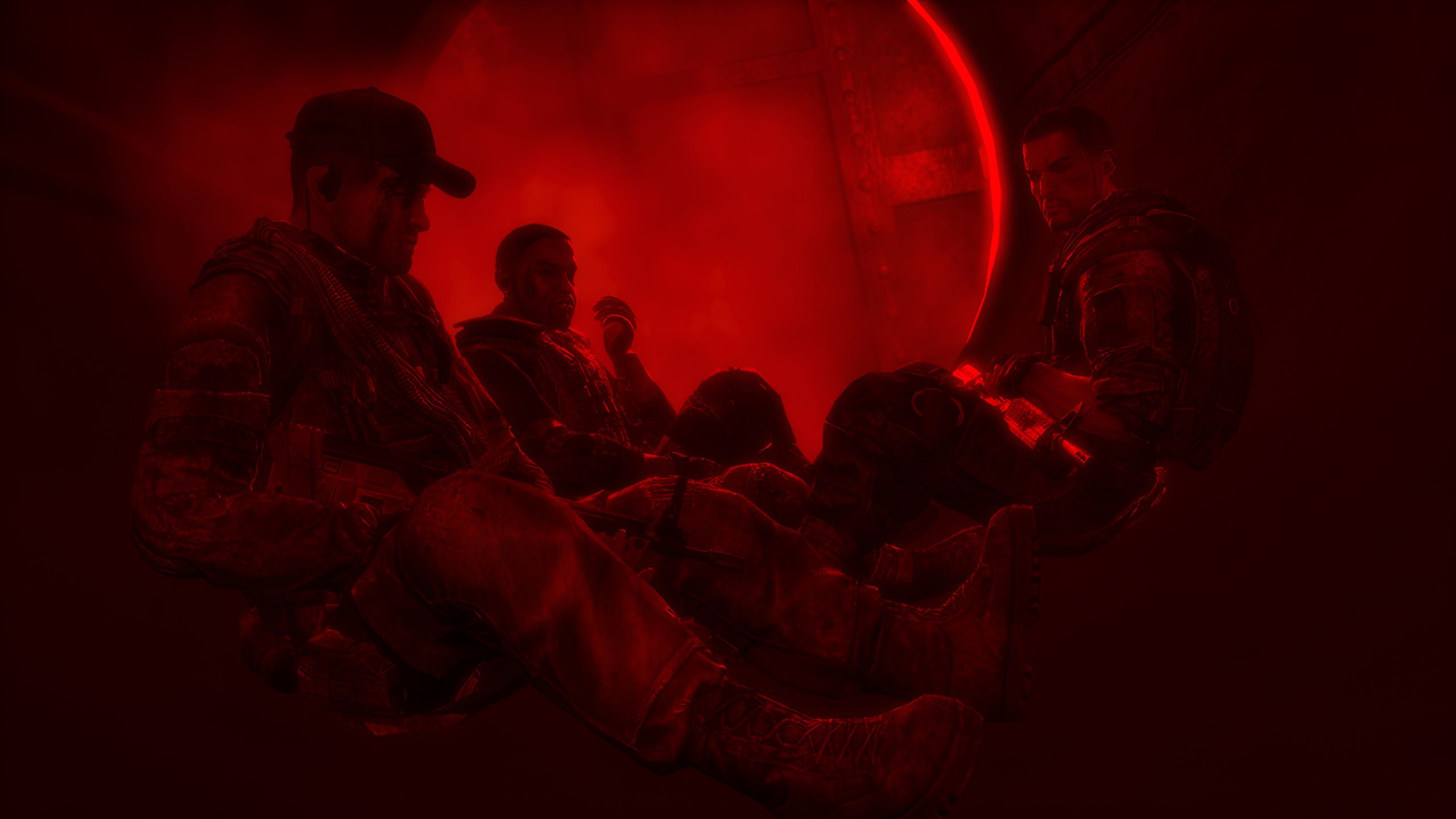 Martin Walker and his comrades sitting together, bathed in red light, in Spec Ops: The Line.