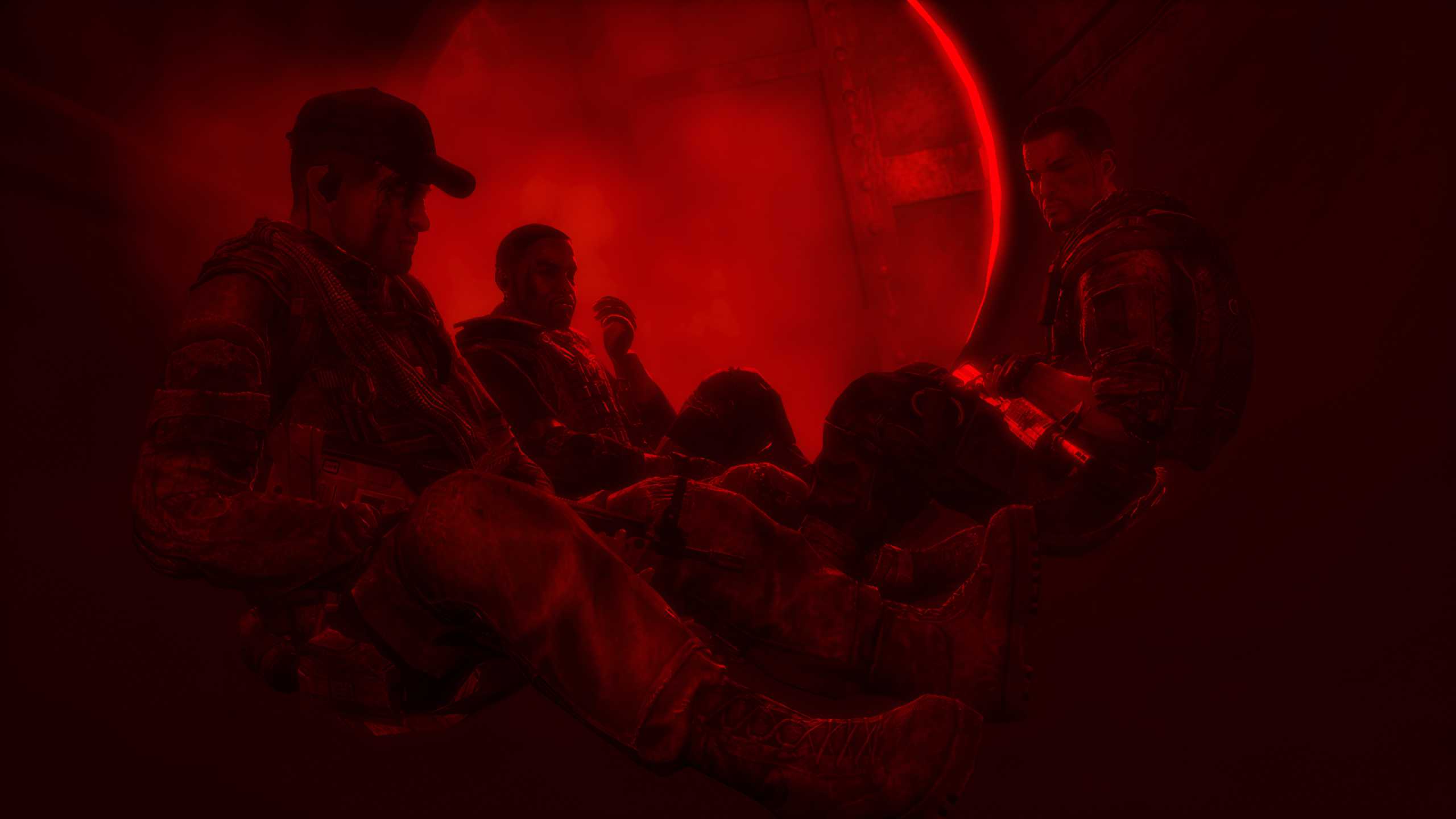 Martin Walker and his comrades sitting together, bathed in red light, in Spec Ops: The Line.